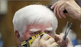  ?? Charlie Neibergall/Associated Press ?? A man gets his hair cut May 15 in Des Moines, Iowa.