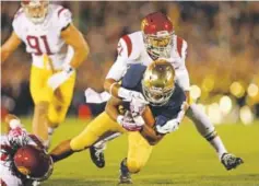  ??  ?? Su’a Cravens, tackling Notre Dame’s George Atkinson III, was an athletic safety/linebacker hybrid at Southern Cal. Getty Images file