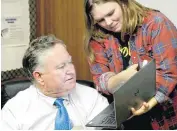  ??  ?? Candidate Tom Guild’s expression reveals his shock and disappoint­ment when senior campaign staffer Crystal Davis shows him the vote tally after the final precincts were added to the count; the final unofficial vote numbers revealed that Guild had...