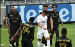  ?? PHOTO BY RAUL ROMERO JR. ?? LAFC's Carlos Vela, right. celebrates after scoring a goal against the Galaxy during a 2020 game at Banc of California Stadium. The Galaxy leads the series, 5-3-5.