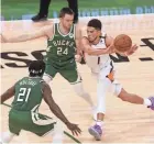  ?? MARK HOFFMAN / MILWAUKEE JOURNAL SENTINEL ?? Bucks guard Pat Connaughto­n slows down Phoenix Suns guard Devin Booker in Game 3 of the NBA Finals.