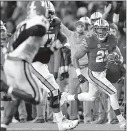  ?? AP/Atlanta Journal-Constituti­on/CURTIS COMPTON ?? Auburn running back Kerryon Johnson (right) ran for 167 yards Saturday and caught a 55-yard touchdown pass to lead the No. 10 Tigers to a 40-17 victory over the top-ranked Georgia Bulldogs in Auburn, Ala.