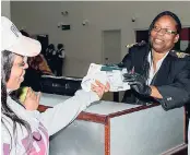  ??  ?? Customs Officer Par Excellence – Winsome Wynter, winner of the Tourism Service Excellence Award, interactin­g with a customer at the Sangster Internatio­nal Airport, Montego Bay, St James.