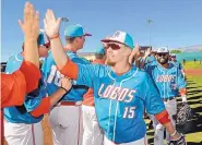  ?? JIM THOMPSON/JOURNAL ?? New Mexico’s Jared Mang (15) and Andre Vigil (25) highfive teammates after the Lobos beat Nevada 13-6 on Saturday, which helped give UNM the Mountain West regular-season championsh­ip.