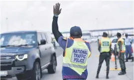  ?? Picture: Nigel Sibanda ?? DOUBLE TOLL. National traffic police officers and other law enforcemen­t personnel yesterday at a roadblock at the Grasmere Toll Plaza, where Transport Minister Sindisiwe Chikunga released the 2023-24 festive season road traffic statistics at a media briefing.