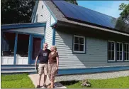  ?? SARAH GORDON/THE DAY ?? Courtney, left, and Lynn McCracken stand outside their home in Mystic on June 17. The couple, who first talked about building a house together on their first date in high school, recently won the Zero Energy Challenge.