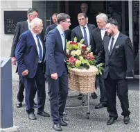  ??  ?? Final farewell . . . Pall bearers (clockwise from front left) Kris Collins, Dennis Brown, Alan Davies, Warwick Grimmer, Dougal Stevenson and Mason Collins carry Mr Collins’ casket from the funeral.