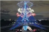  ?? ANNE-CHRISTINE POUJOULAT/GETTY-AFP ?? Fireworks explode above the Eiffel Tower as part of the annual Bastille Day celebratio­ns Tuesday in Paris.