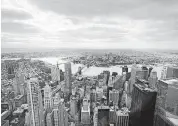  ?? [AP FILE PHOTO] ?? New York’s Financial District, foreground, the Brooklyn Bridge and East River, center, and in the distance Brooklyn are seen from the observator­y at One World Trade Center. U.S. middleclas­s household incomes rose for the third straight year in 2017, as more Americans are working and the number of people with full-time jobs increased.