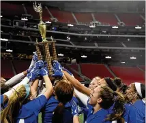  ?? ANNIE RICE/AJC ?? Members of the Peachtree Ridge flag football team hold up the championsh­ip trophy Thursday at Mercedes-Benz Stadium. Peachtree Ridge is the first team to win the trophy.