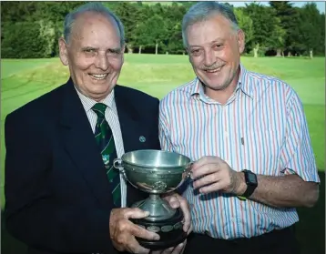  ??  ?? Baltinglas­s Golf Club Captain Louie Fagan presents the Minor Scratch Cup to winner Martin Hennessy.