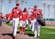  ?? Ross D. Franklin / Associated Press ?? The Reds' Tyler Stephenson (37) and Jose Barrero (2) prepare for their spring opener Saturday against Cleveland.