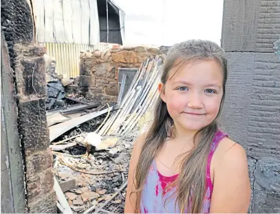  ?? Picture: Dougie Nicolson. ?? Firefighte­rs used water from the swimming pool next door to tackle the blaze after the alarm was raised by plucky Fife schoolgirl Analice Peebles, above.