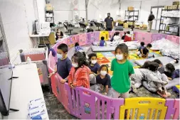  ?? DARIO LOPEZ-MILLS ASSOCIATED PRESS FILE PHOTO ?? Young unaccompan­ied migrants, from ages 3 to 9, watch television last month from a playpen at a U.S. Customs and Border Protection facility in Donna, Texas. Although the Donna facility is designed to hold them no more than 48 hours, many kids stay there for a week or longer while waiting to be transferre­d elsewhere.