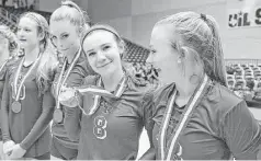  ?? Jerry Baker ?? George Ranch senior Abbey Messick (8), sandwiched between teammates Ambrielle Logan and Cheyenne Horst, right, shows off her medal after the Longhorns’ Class 5A volleyball tournament showing.