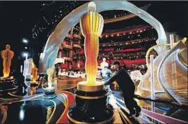  ?? Al Seib Los Angeles Times ?? CREWS prepare the Dolby Theatre for the Oscars. As the academy’s public image struggles, the famed statuette seems to have lost some of its luster to film studios.