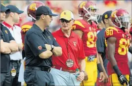  ?? Luis Sinco
Los Angeles Times ?? STEVE SARKISIAN, left, chats in September with AD Pat Haden, who interviewe­d Chris Petersen — Washington’s coach — for job Sarkisian eventually got.