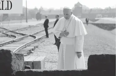  ?? L’OSSERVATOR­E ROMANO / THE ASSOCIATED PRESS ?? Pope Francis prays in front of a memorial at the former Nazi death camp of Auschwitz-Birkenau in Poland. The Pope spent most of his two-hour visit to the site in total silence, except for a few words shared with survivors and rescuers.