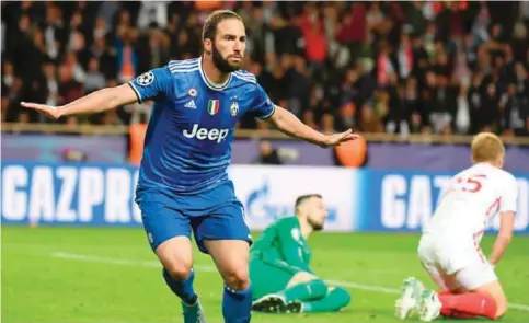  ?? — AFP ?? MONACO: Juventus’ forward from Argentina Gonzalo Higuain reacts after scoring a second goal during the UEFA Champions League semi-final first leg football match Monaco vs Juventus at the Stade Louis II stadium.