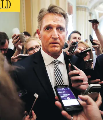 ?? JACQUELYN MARTIN/THE ASSOCIATED PRESS ?? Sen. Jeff Flake is questioned by reporters about Supreme Court nominee Brett Kavanaugh on Capitol Hill on Friday.