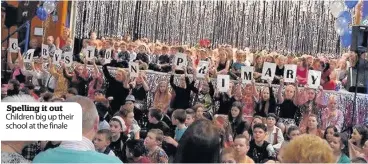  ??  ?? Spelling it out Children big up their school at the finale