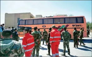  ?? AP/SANA ?? Syrian government forces oversee the evacuation of Army of Islam fighters and their families from the besieged town of Douma, just east of Damascus, Syria, on Monday.