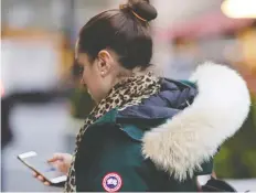  ?? FRANK FRANKLIN II / THE CANADIAN PRESS FILES ?? A woman in New York wears a Canada Goose coat earlier this year. The clothing company has long been in the crosshairs of PETA.