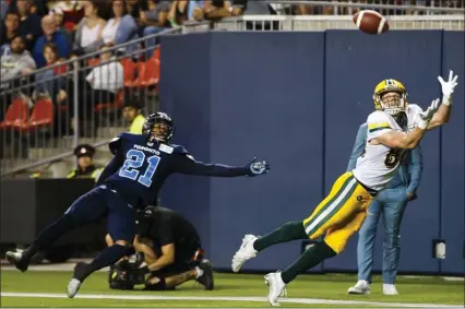  ?? The Canadian Press ?? Edmonton Eskimos’ Greg Ellingson makes a diving touchdown catch against Toronto Argonauts’ Qudarius Ford during the second half of their CFL game in Toronto, Friday.