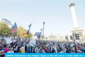  ?? — AFP ?? LONDON: Demonstrat­ors pass Trafalgar Square as they take part in a march calling for a People’s Vote on the final Brexit deal, in central London yesterday.