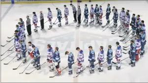  ?? JASON SIMMONDS/JOURNAL PIONEER ?? The Summerside Western Capitals, Edmundston Blizzard and the on-ice officials stood around centre ice for a moment of silence in memory of the victims of the Humboldt Broncos bush crash on Friday, and for the playing of O! Canada before Monday night’s...