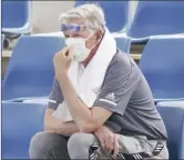  ?? AAP Image via AP MICHAEL DODGE photo ?? A spectator wears a mask as smoke haze shrouds Melbourne Park during an Australian Open practice session Tuesday.