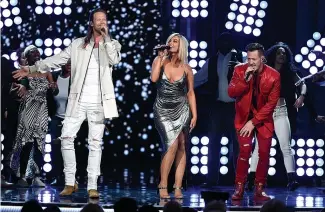  ?? Associated Press ?? ■ Tyler Hubbard, right, and Brian Kelley, left, of Florida Georgia Line, and Bebe Rexha, center, perform "Meant to Be" at the 53rd annual Academy of Country Music Awards in Las Vegas. The two are nominated for a Grammy Award with pop singer Rexha for best country duo/group performanc­e for their chart busting hit of the year.