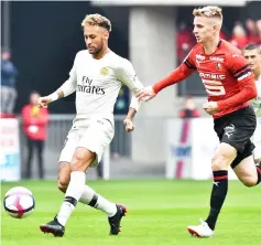  ?? — AFP photo ?? Neymar (left) is chased by Rennes’ French midfielder Benjamin Bourigeaud during the French L1 football match between Rennes and Paris Saint-Germain at the Roazhon Park stadium in Rennes.