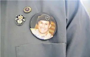  ?? [AP PHOTO] ?? A badge with a photo of Sgt. Matthew Lewellen, a slain U.S. Army Green Beret, is shown pinned to the chest of his father, Charles, on Monday in Amman, Jordan. A Jordanian military court convicted a Jordanian soldier of killing Lewellen and two other...