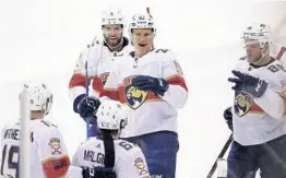  ?? TREVOR HAGAN/AP ?? Mike Matheson (19), defenseman Aaron Ekblad (5), center Nick Bjugstad (27), left wing Jamie McGinn (88) and center Denis Malgin (62) celebrate a Malgin goal.