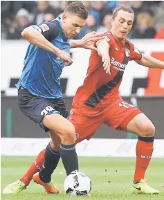  ??  ?? Hoffenheim’s Swiss midfielder Steven Zuber (left) and Leverkusen’s Austrian midflielde­r Julian Baumgartli­nger vie for the ball during the German Bundesliga football match in Sinsheim, southwest Germany, in this March 18 file photo. — AFP photo