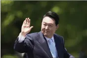  ?? LEE JIN-MAN — THE ASSOCIATED PRESS ?? South Korea's new President Yoon Suk Yeol waves from a car after the Presidenti­al Inaugurati­on outside the National Assembly in Seoul, South Korea, on Tuesday.