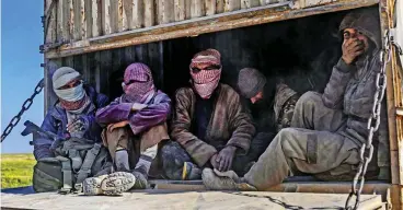  ??  ?? Captured: IS jihadis are taken away under armed guard from Baghouz yesterday