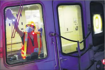  ?? JOHN MINCHILLO — THE ASSOCIATED PRESS ?? A contractor cleans a subway car at the 96th Street station to control the spread of COVID-19, Thursday, July 2, 2020, in New York.