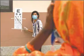  ??  ?? A patient gets her eye checked during her follow-up exam after her cataract surgery at an eye camp in Lumbini.
(AP/Bikram Rai)