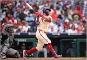  ?? MATT SLOCUM – THE ASSOCIATED PRESS ?? Philadelph­ia Phillies' Kyle Schwarber follows through after hitting a home run against Chicago White Sox pitcher Deivi Garcia during the sixth inning on Sunday in Philadelph­ia.