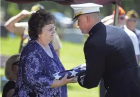  ?? RON PAGE USA TODAY NETWORK-WISCONSIN ?? Sgt. Elden W. Grimm’s niece,
Margaret Kersten, is presented with the flag by Capt. Nicholas Pecoraro during the ceremony Saturday in Neenah.