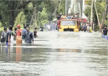  ?? PICTURE: AP ?? DELUGE: A truck carries people through floodwater­s in Thrissur, Kerala state, India.