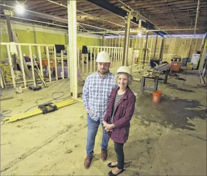  ?? Photos by Paul Buckowski / Times Union ?? Brandon Whittall and his wife Michelle Whittall, owners of the Clinton Street Mercantile, stand on the ground floor at 144 Clinton Street on Tuesday in Schenectad­y.