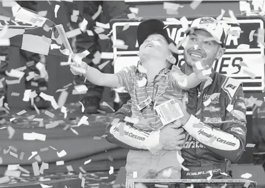  ?? RICK SCUTERI/AP ?? Kyle Larson, right, and his son Owen celebrate after winning a NASCAR Cup Series championsh­ip last November in Avondale, Arizona.