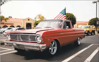  ?? KRISTIAN CARREON PHOTOS ?? Al Sherwood’s Ford Ranchero carries an American flag. Sherwood is a retired Navy veteran from National City who participat­ed in the flag parade Saturday in Chula Vista that honored victims of 9/11.