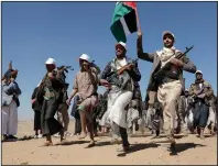  ?? (AP) ?? Houthi fighters march on Yemen outside Sanaa on Jan. 22 during a rally of support for the Palestinia­ns in the Gaza Strip and against the U.S. strikes.