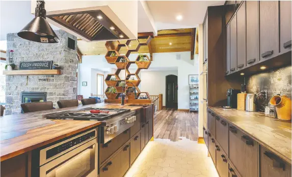  ??  ?? The living wall on a kitchen island adds a fun element to this Carleton Kitchen & Bath project.