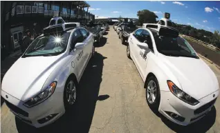  ?? Gene J. Puskar / Associated Press 2016 ?? Uber is testing autonomous cars such as these introduced in Pittsburgh last year. The turmoil at the company could mean it will take longer to reach its robot-taxi goals.