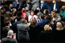  ?? NEW YORK TIMES ?? Democrats celebrate with Speaker of the House Nancy Pelosi (center) at the Capitol on Friday, after passing the centerpiec­e of President Joe Biden’s domestic agenda.